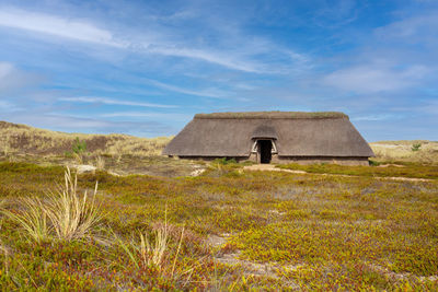 Panoramic image of a traditional house within the dunes of amrum, north sea, germany