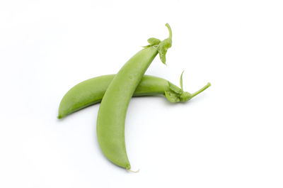 Close-up of green chili pepper against white background