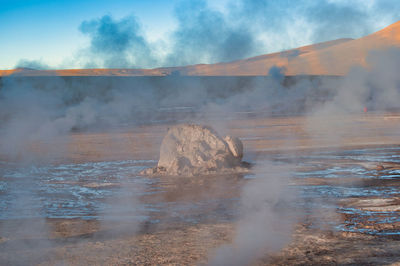 Smoke emitting from volcanic landscape