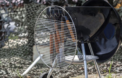 Close-up of barbecue grill with cooking utensils