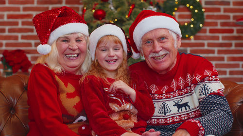 Portrait of smiling grandparents and granddaughter