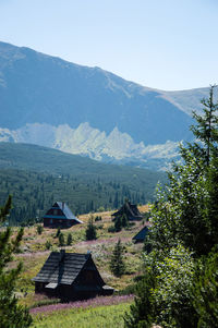 Houses and mountains against clear sky