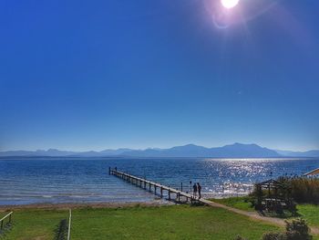 Scenic view of sea against clear blue sky