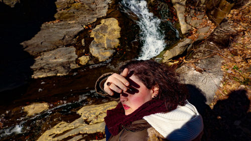 High angle portrait of woman on rock