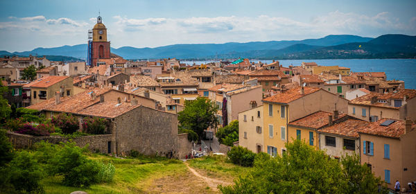 Buildings in town against sky