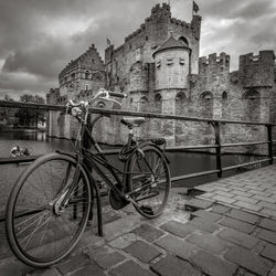 Bicycle parked against building