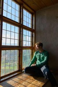 Man sitting by window at home