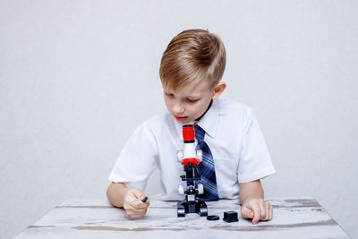 Boy looking at camera on table