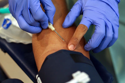 Cropped image of doctor preparing patient for blood donation