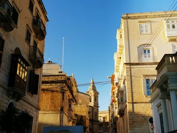 Low angle view of buildings against clear sky