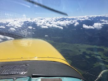 Close-up of airplane on landscape against sky