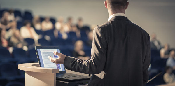 Midsection of man using laptop