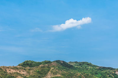 Low angle view of mountain against blue sky