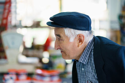 Close-up of senior man contemplating indoors