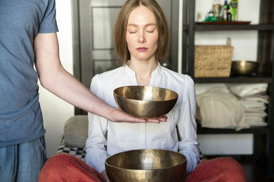 Midsection of woman holding ice cream at home