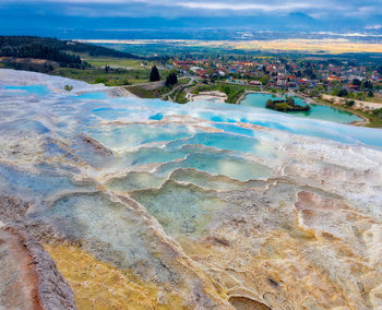 High angle view of sea shore against cloudy sky