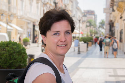 Portrait of smiling woman in city