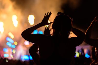 Rear view of woman at night