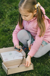 High angle view of girl drawing on field