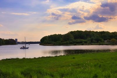 Scenic view of lake against sky during sunset