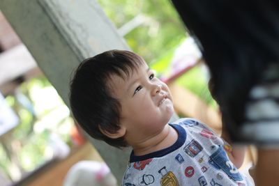 Tilt image of cute boy looking away outdoors