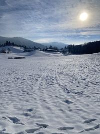 Scenic view of snow covered landscape against sky