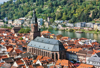 High angle view of buildings by river in town