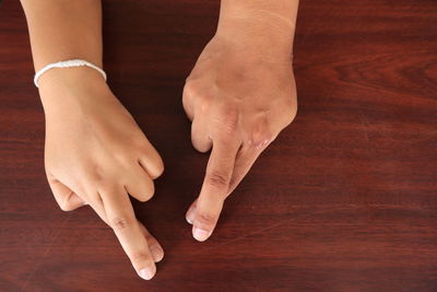 Close-up of woman hand on table