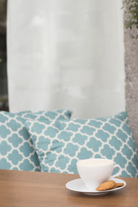 Close-up of tea on table against blue pillows