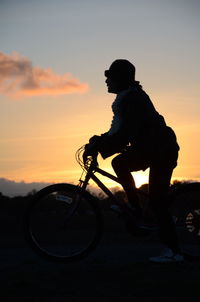 Silhouette person at sunset