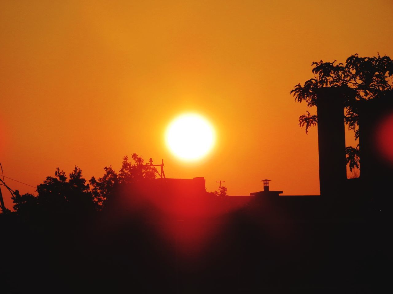 sun, sunset, orange color, tree, silhouette, sunbeam, sunlight, no people, beauty in nature, nature, tranquility, scenics, outdoors, built structure, architecture, sky, building exterior, day