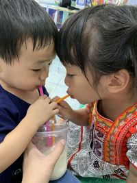 Rear view of cute girl drinking food