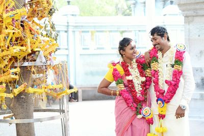 Happy couple standing at temple