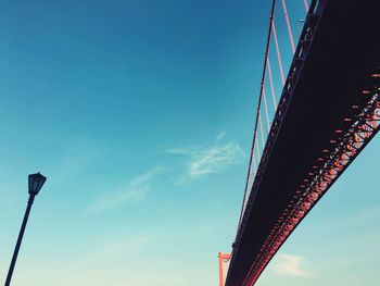 Low angle view of bridge against cloudy sky