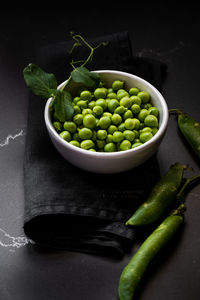 High angle view of green peas in bowl on table