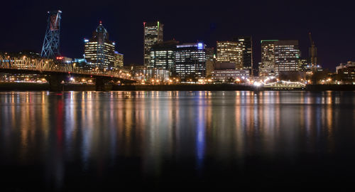 Illuminated city at waterfront