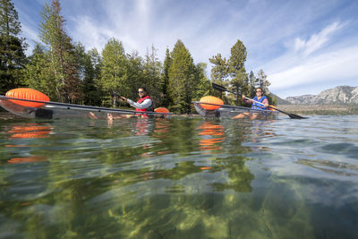 Kayakers enjoying a summer morning paddling on lake tahoe, ca