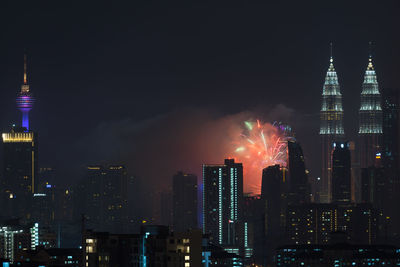 View of skyscrapers lit up at night