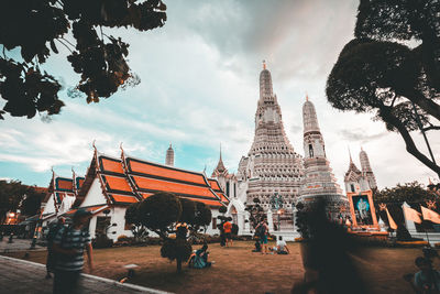 Group of people outside temple against buildings