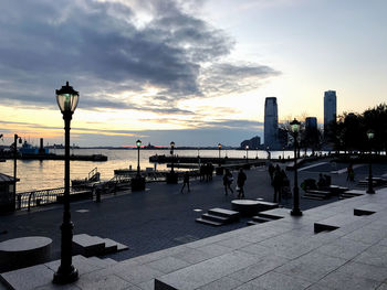 City at waterfront during sunset