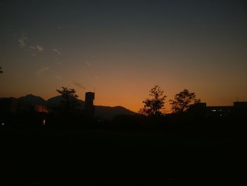 Silhouette trees against sky during sunset