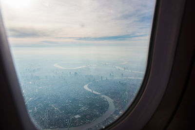 Aerial view of cityscape seen through airplane window