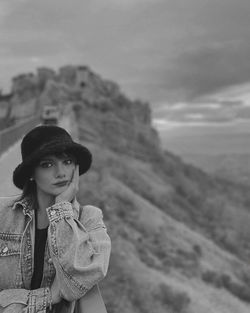 Portrait of teenage girl standing against sky