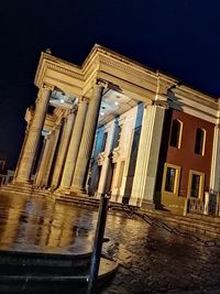 Low angle view of illuminated building against sky at night