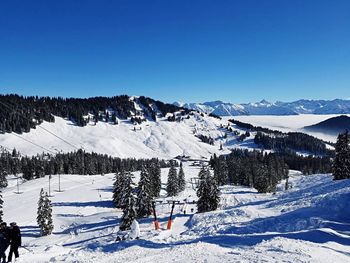 Scenic view of mountains against clear blue sky