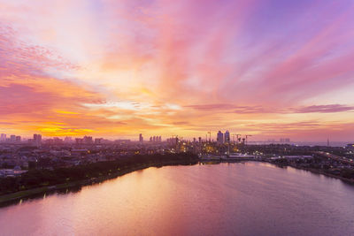 City buildings against cloudy sky during sunset