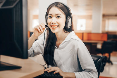 Portrait of smiling young woman using smart phone