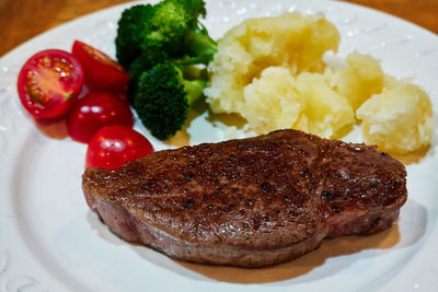 Close-up of homemade steak and vegetables served in plate