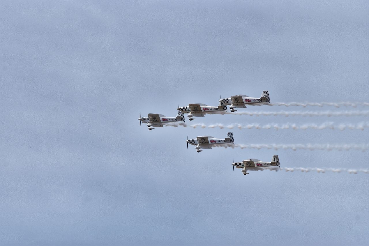 sky, cloud - sky, built structure, nature, no people, day, building exterior, architecture, low angle view, outdoors, copy space, air vehicle, travel, building, smoke - physical structure, airplane, industry, mid-air, flying, motion