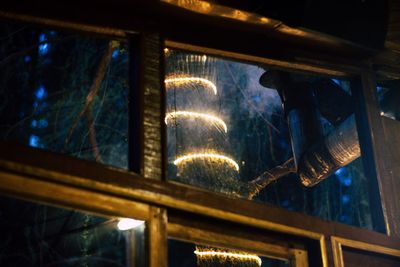 Low angle view of illuminated lights at night